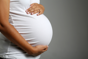 Image of a pregnant person close up on bump